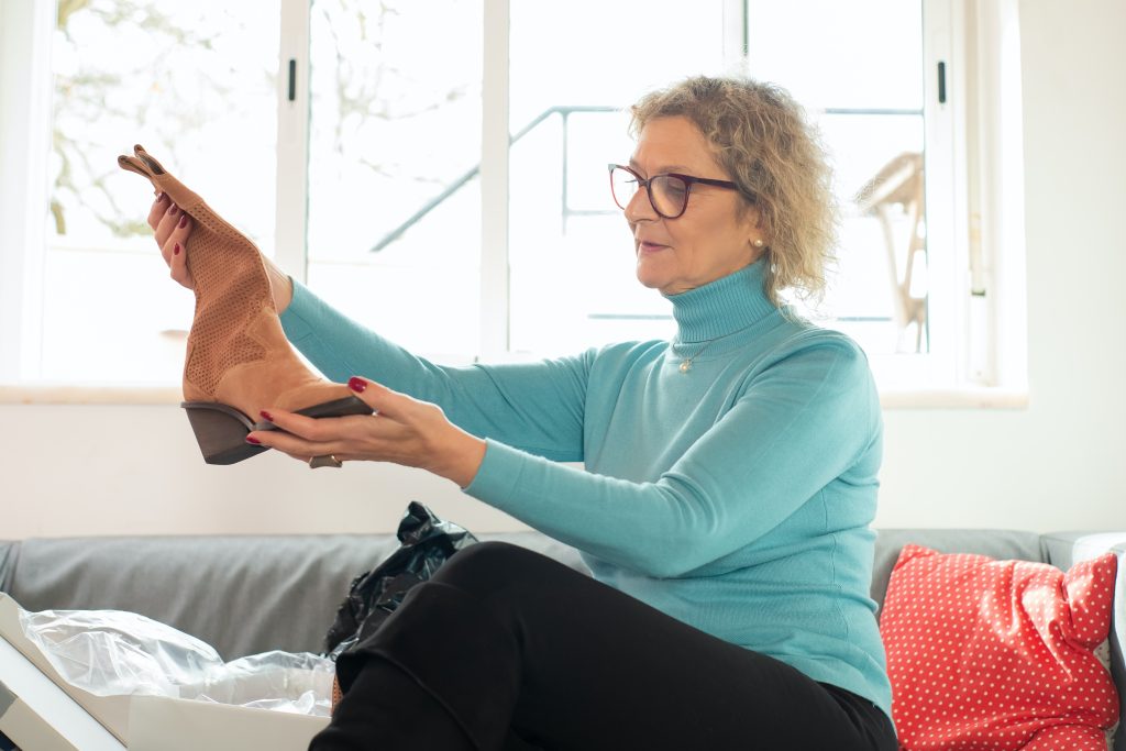 woman holding shoe